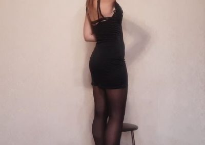 Backside view of Girl In Black Dress and Black pantyhose