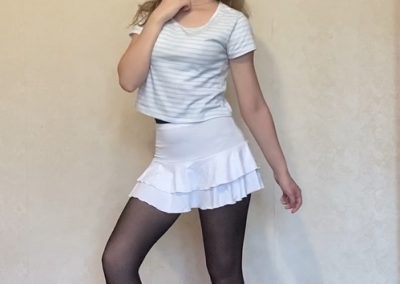 Stacy In Flirty White Dress and black pantyhose posing