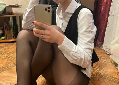 Sexy Girl in dress shirt and black pantyhose sitting taking selfie