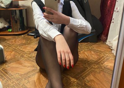 Nerdy Girl In Dress Shirt and Pantyhose Sitting Sending Selfie