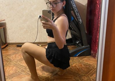 Real girl wearing glasses taking selfie in skirt and pantyhose