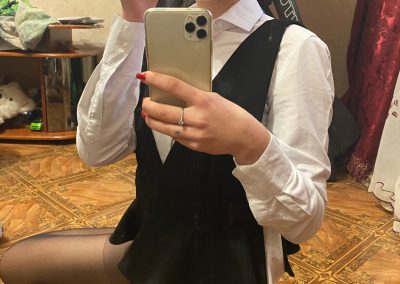 Girl wearing glasses and black pantyhose sitting sending selfie