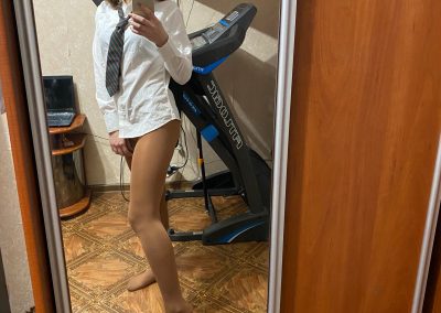 Schoolgirl taking selfies in her uniform shirt and pantyhose