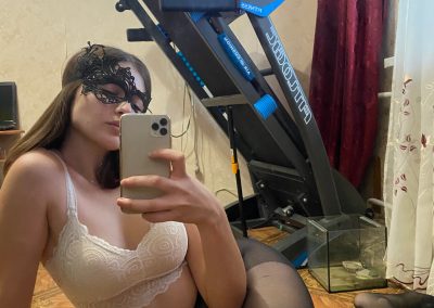 Sexy girlfriend on her side in bra,panties and pantyhose selfie