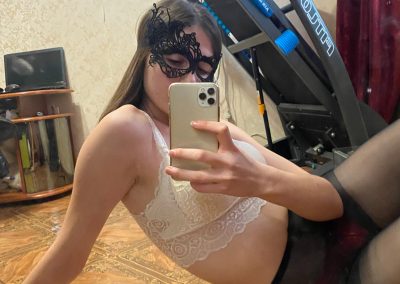 Sexy girlfriend sitting on floor sending selfies in pantyhose