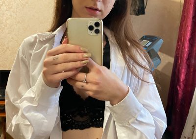 Amateur with her shirt unbuttoned taking selfie