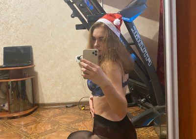 hot girl with santa hat taking selfie of backside in pantyhose