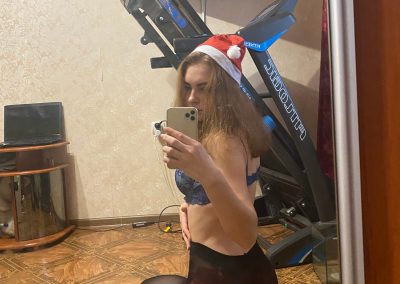 Sexy girl with santa hat taking pic of backside in selfie in pantyhose