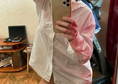 Hot babe in dress shirt taking selfie in pantyhose