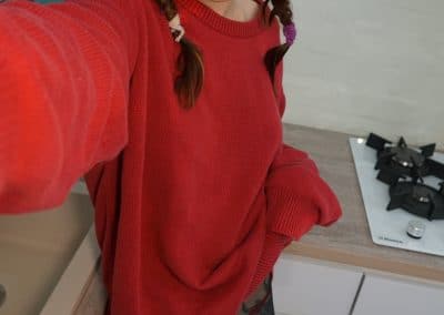 Asian hottie in red sweater and pantyhose with pigtails
