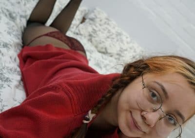 Asian girl in black pantyhose and panties and red sweater