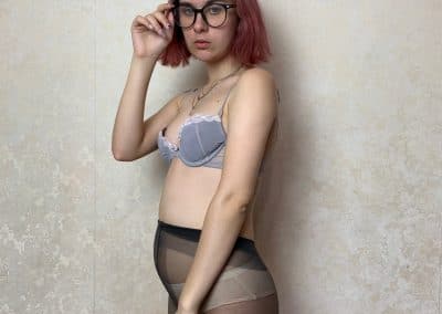 Pink hair lady wearing pantyhose and glasses