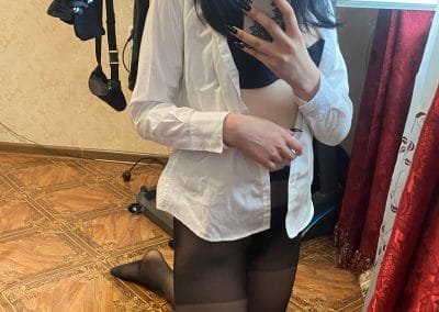 Hot nerdy girl on her knees wearing pantyhose taking selfie