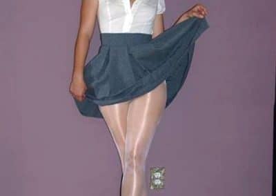 Brunette Lifting Her Skirt Showing Shiny White Pantyhosed Legs