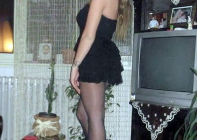 Pretty Girl In Black Cocktail Dress and Pantyhose and High Heels