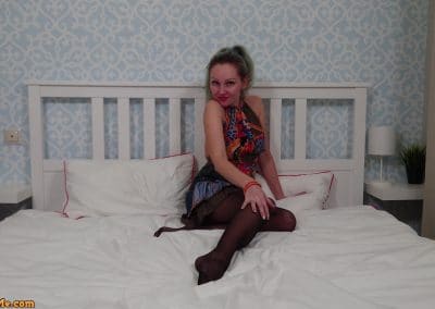 Mom in dress and black pantyhose on the bed