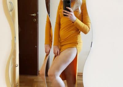 Bleach Blonde In Yellow Dress Showing Her Legs in pantyhose thru slit